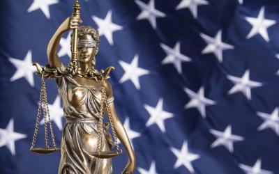 lady justice in fornt of american flag