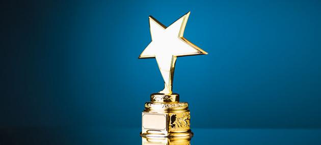 gold star trophy with blue backdrop