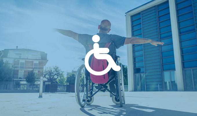 man in wheelchair with arms out as though flying