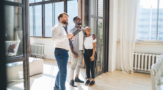 realtor showing a man and his daughter an apartment