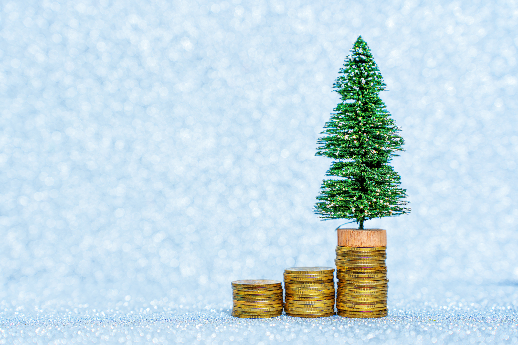 holiday tree on rising coin stacks