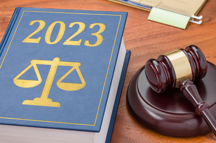 Photo of gavel and book with "2023"
