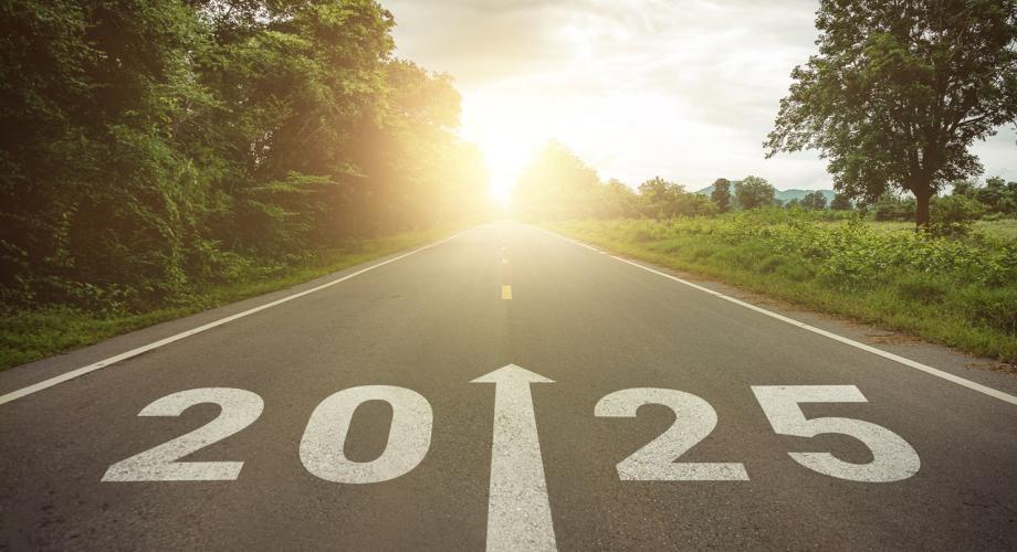 road with 2025 painted on it and a sunrise at the end of the road