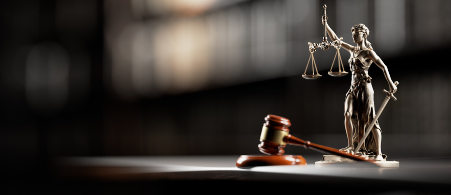 Photo of a gavel with scales of justice.