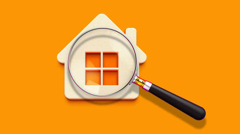 Photo of a house behind a magnifying glass.