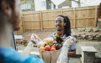 man delivering groceries to a neighbor