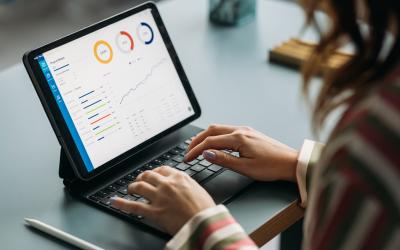 woman looking at data report on ipad