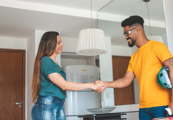 maintenance man shaking hands with a woman