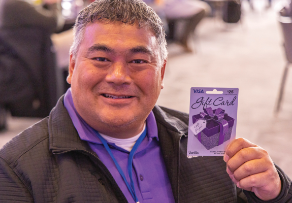 man holding a visa gift card