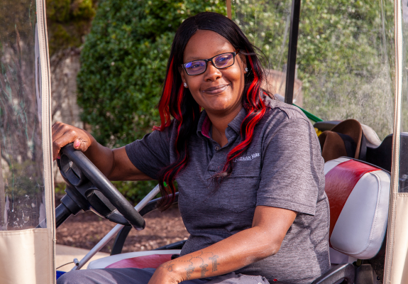 woman on golf cart smiling