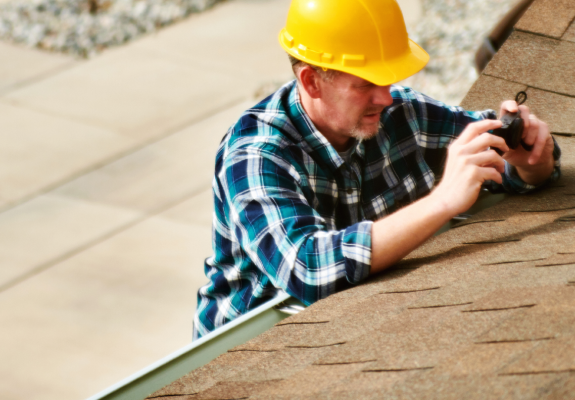 maintenance man repairing a roof