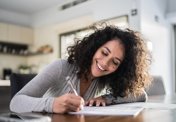 woman signing a piece of paper