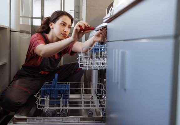 woman repairing dishwasher