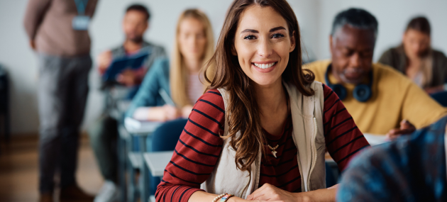 young woman in classroom with other adults learning