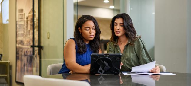 two business women looking at a computer screen in an office