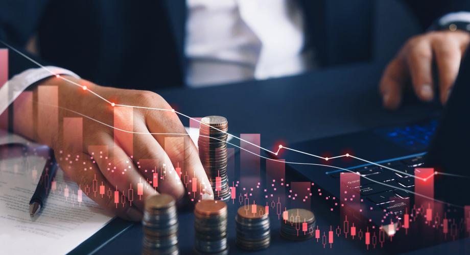 man's hand counting coins with graph overlaid 