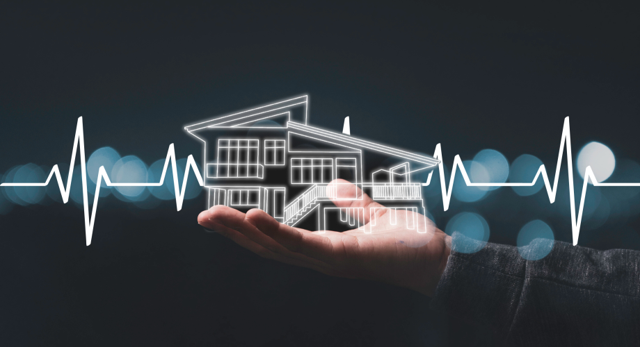 graphic of someone's hand holding an illustration of a house, with a heartbeat graph overlaid