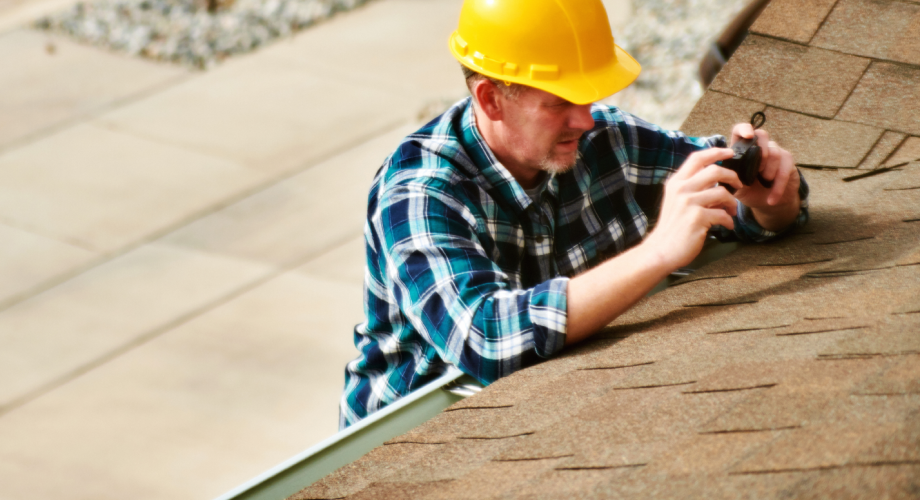 maintenance man repairing a roof