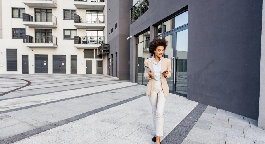 Woman walking in front of the building