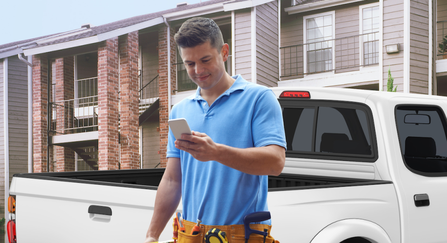 maintenance worker looking at cell phone