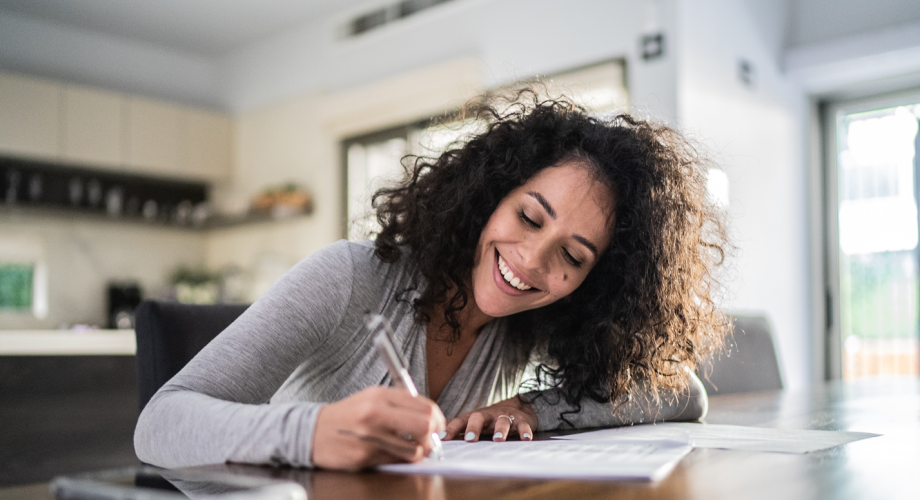 woman signing a piece of paper