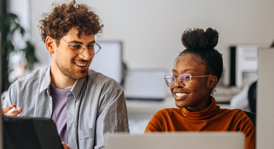 Two people working on computers