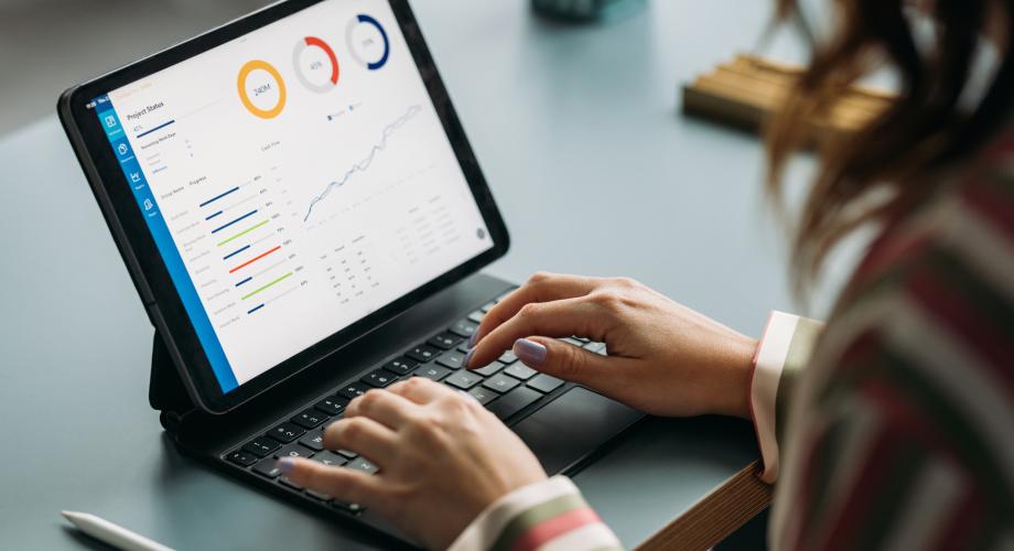 woman looking at data report on ipad