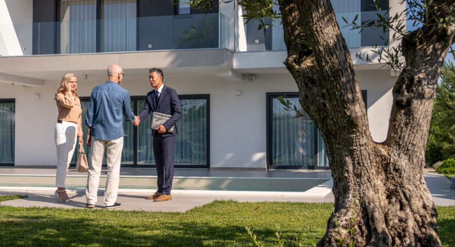 two people meeting leasing agent outside apartment building