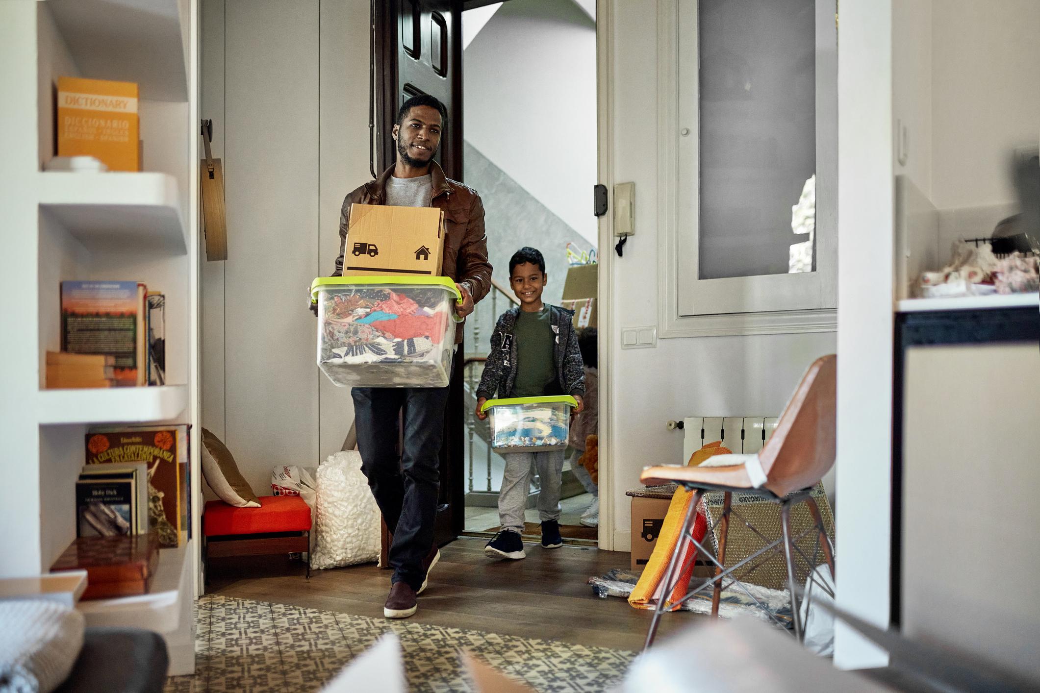 man and son moving into house
