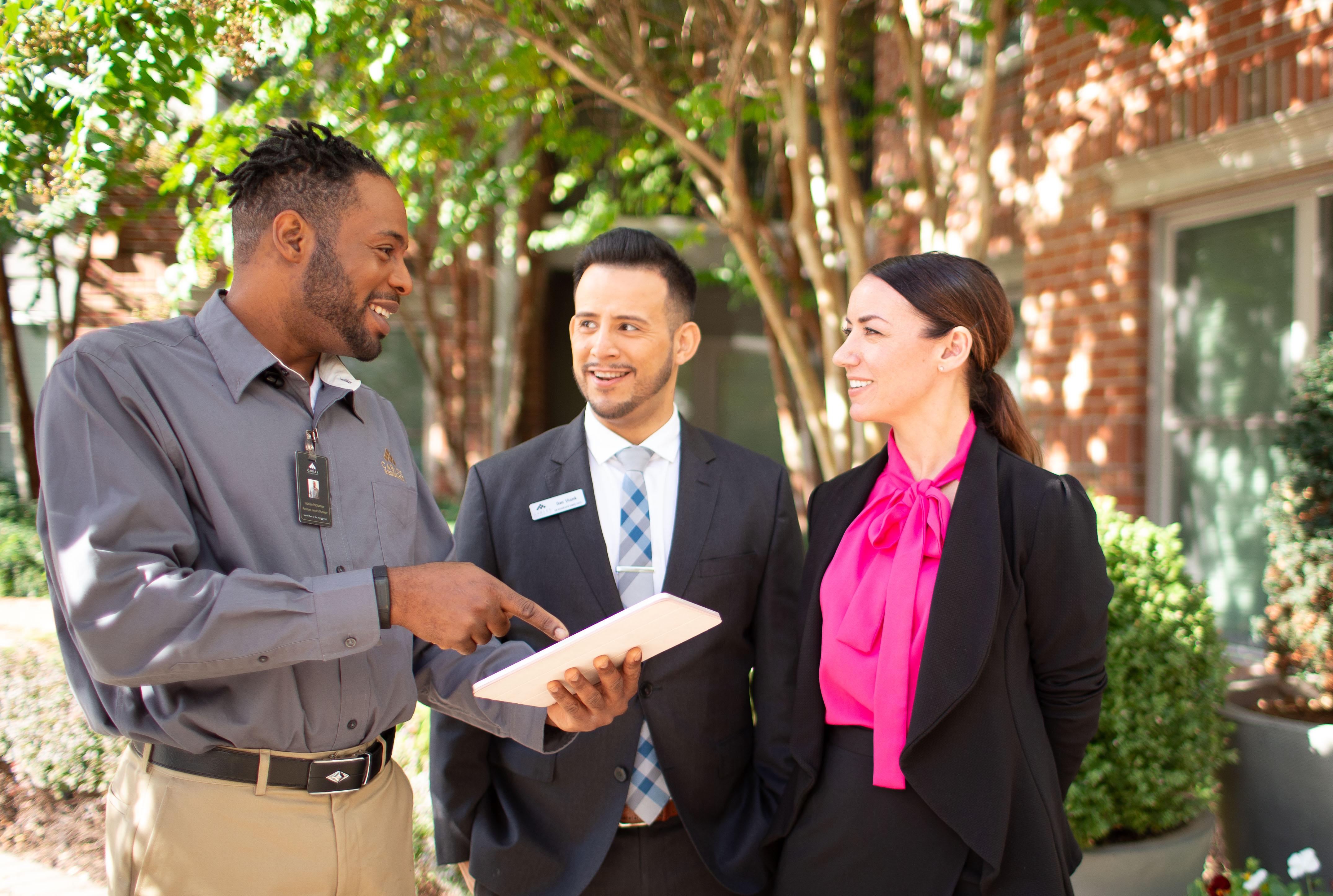 three professionals talking outside