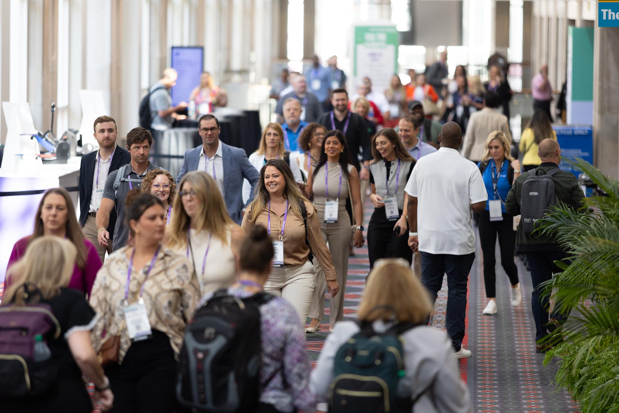 Attendees networking in the halls of Apartmentalize in between education sessions