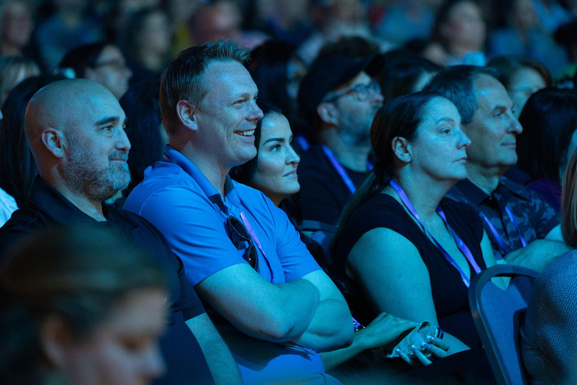 Attendees smile intently listening to Apartmentalize Closing General Session Speaker Mark Wahlberg.