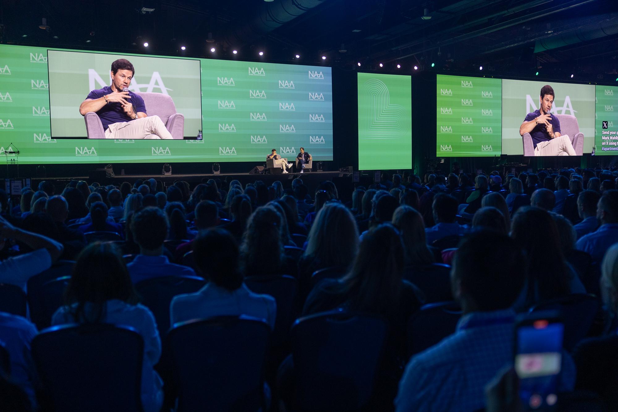 Apartmentalize Emcee Bill Rancic talks with Closing General Session Speaker Mark Wahlberg.