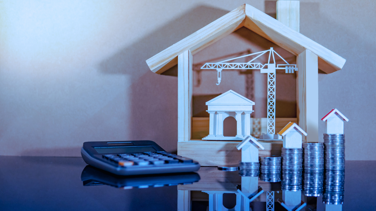 calculator, coins, and house models